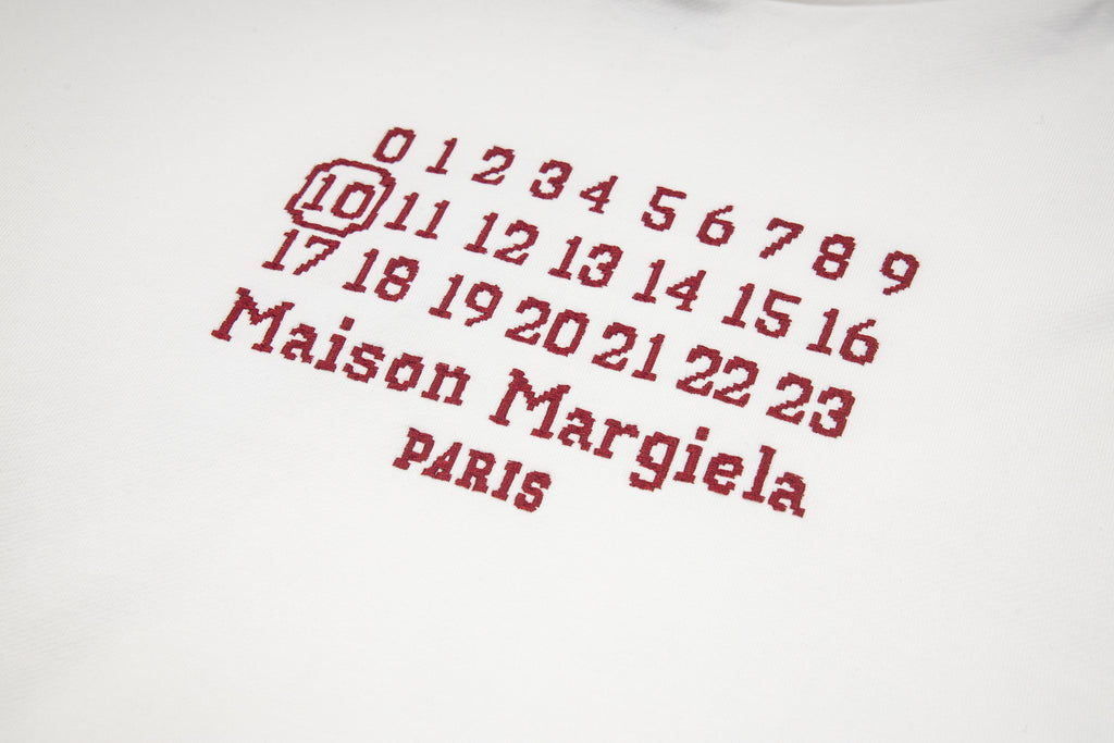 Black Maison Margiela hoodie with red number grid and "Maison Margiela" text