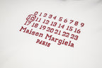 Black Maison Margiela hoodie with red number grid and "Maison Margiela" text