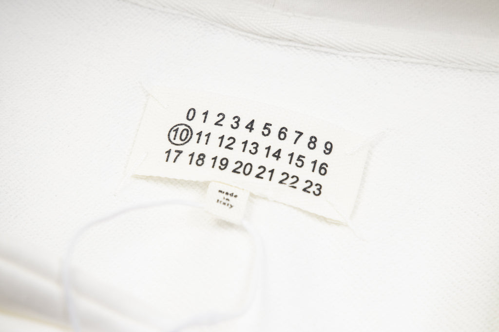 White hoodie fabric with small tag showing number sequence