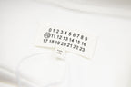 White hoodie fabric with small tag showing number sequence