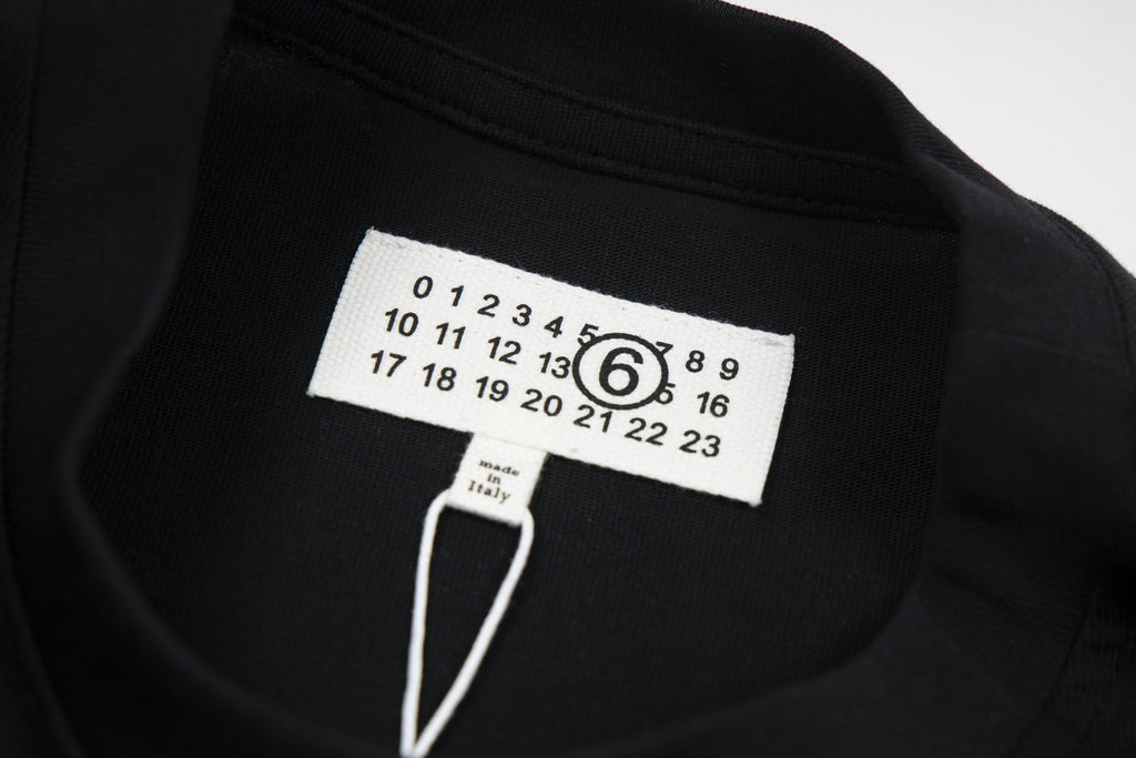 Black T-shirt with Maison Margiela logo size tag at collar