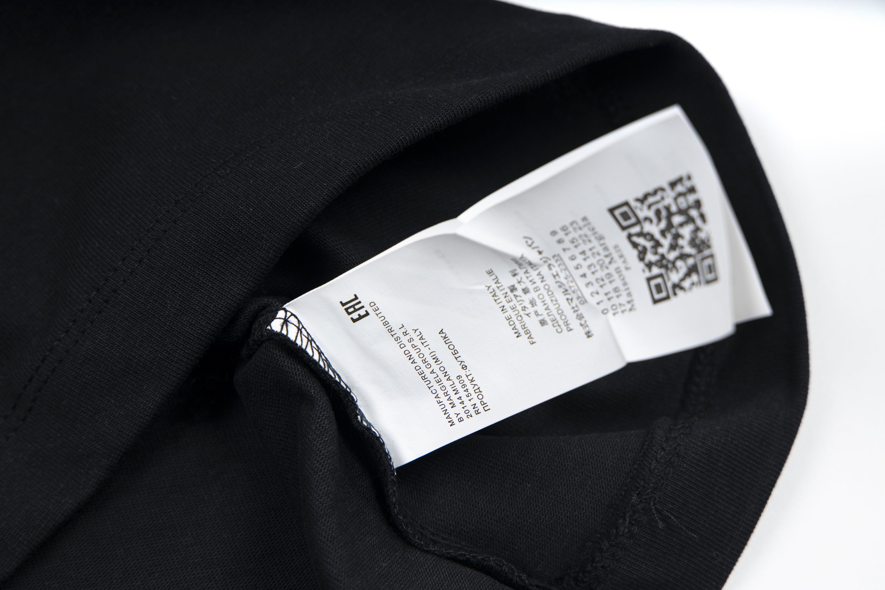 Black T-shirt neck label with QR code and brand tag