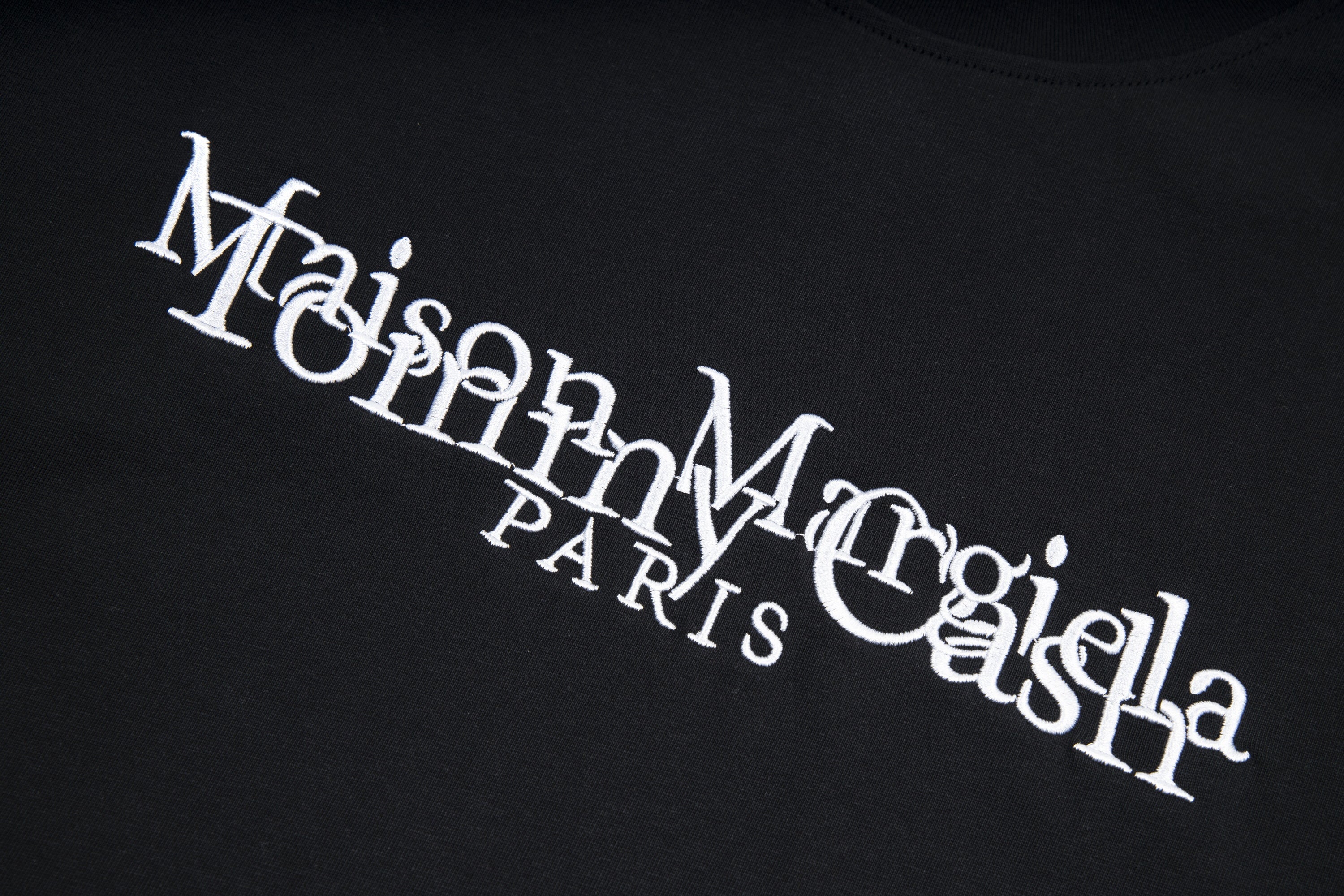 Black T-shirt close-up with Maison Margiela PARIS logo print