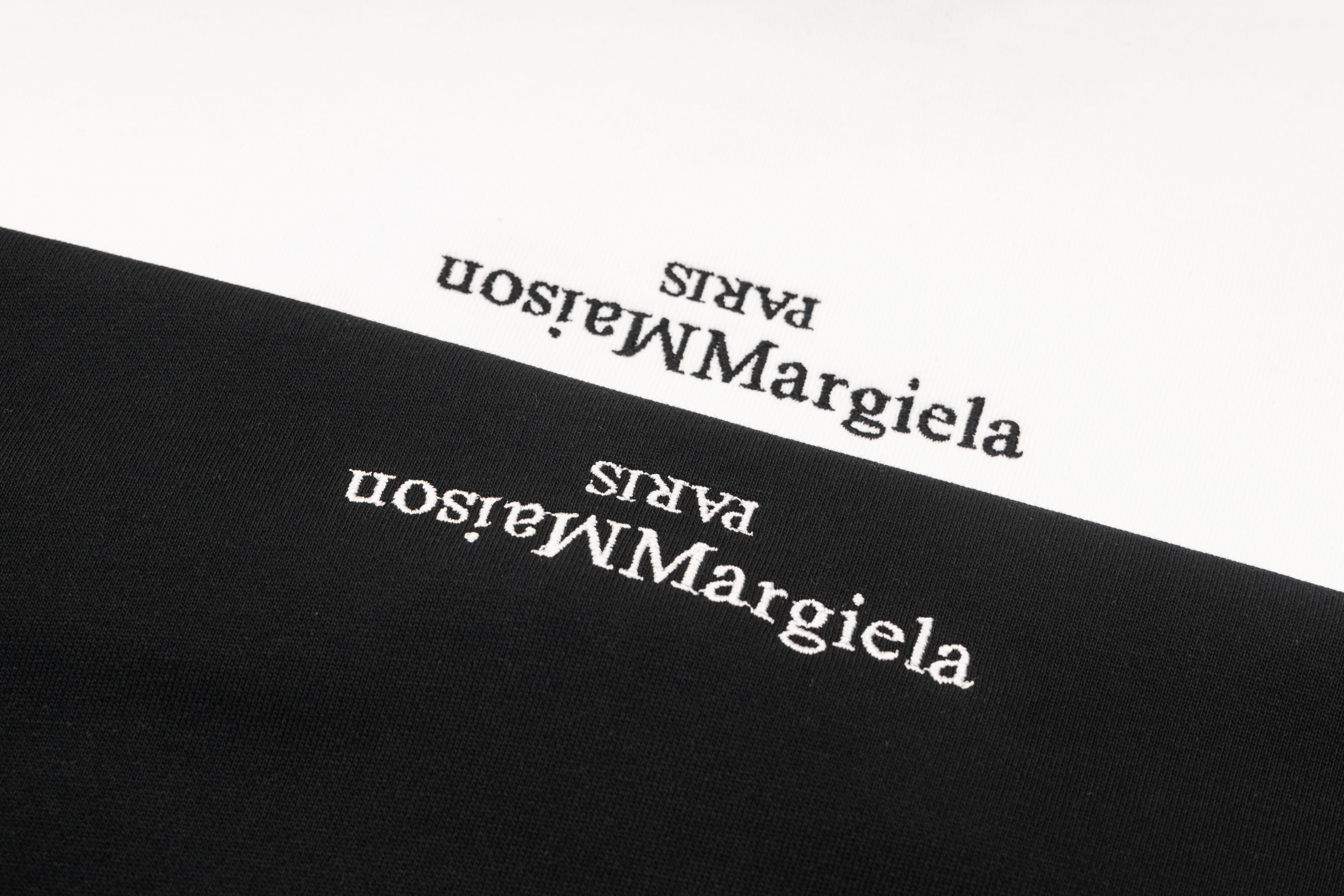 Black sweatshirt logo text close-up near neckline