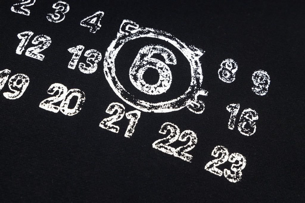 Black sweatshirt with large '6' and scattered white number graphics