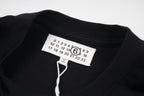 Black crew-neck T-shirt with neck label and numbered graphic print