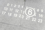Grey hooded sweatshirt fabric with white number graphic and zipper seam detail
