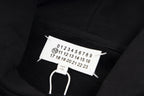 Black hoodie neck tag with size numbers and white drawstrings