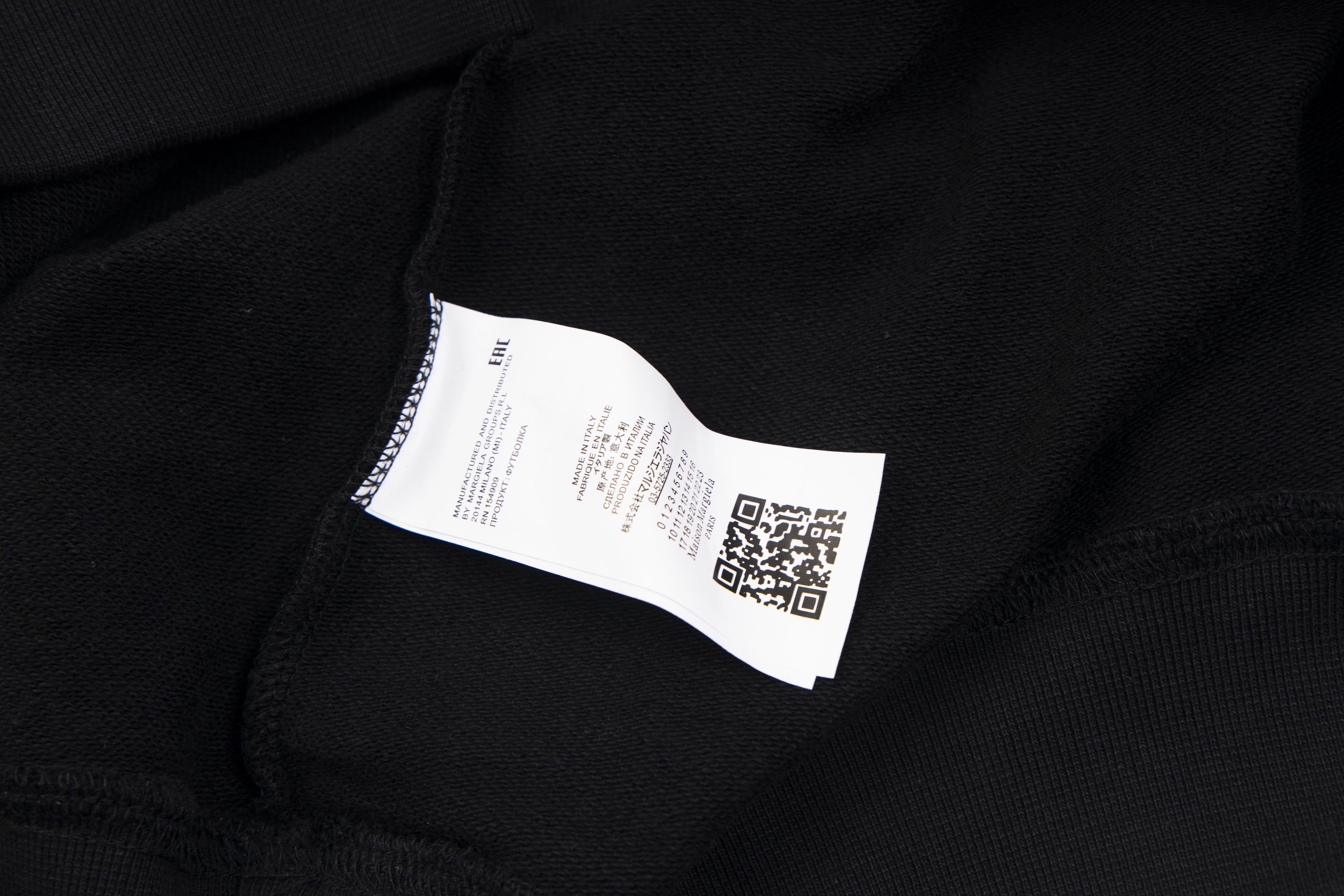 Maison Margiela hoodie neck label on black fabric