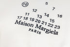 Close-up of Maison Margiela logo and numeric print on a white sweatshirt