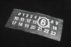 Black sweatshirt chest graphic with numbers inside outlined '6'