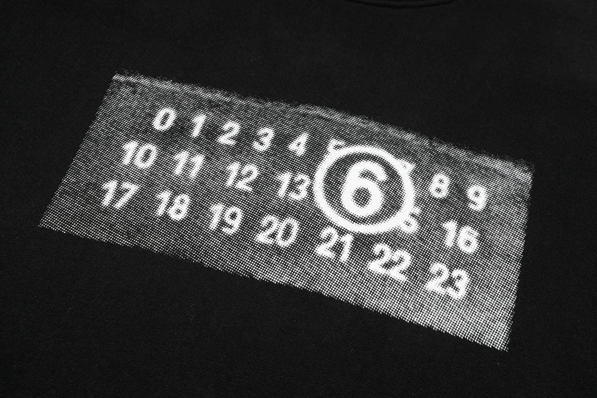 Black sweatshirt chest graphic with numbers inside outlined '6'
