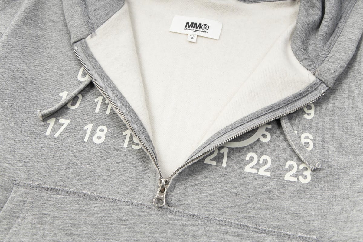Heather grey hooded sweatshirt with half-zip and white number graphic on chest