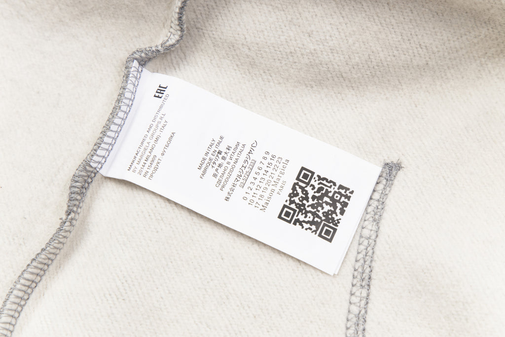 Care and QR label on heather grey hooded sweatshirt hem