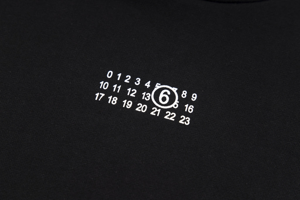 Black hoodie chest graphic with circular numeric logo print