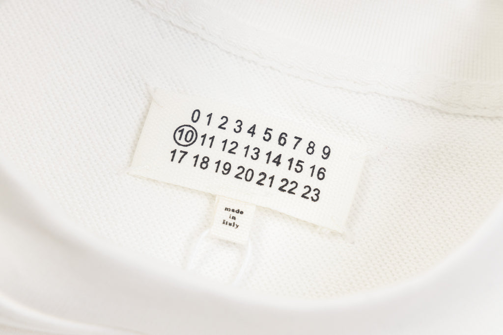 White sweatshirt neck label with size numbers and Maison Margiela text