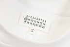 White sweatshirt neck label with size numbers and Maison Margiela text