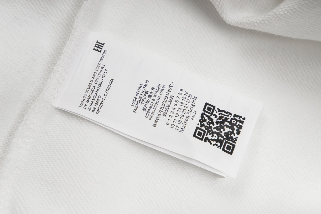 White hoodie care label on inner seam with barcode