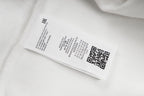 White hoodie care label on inner seam with barcode