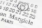 White sweatshirt back graphic with number digits and Maison Margiela PARIS text