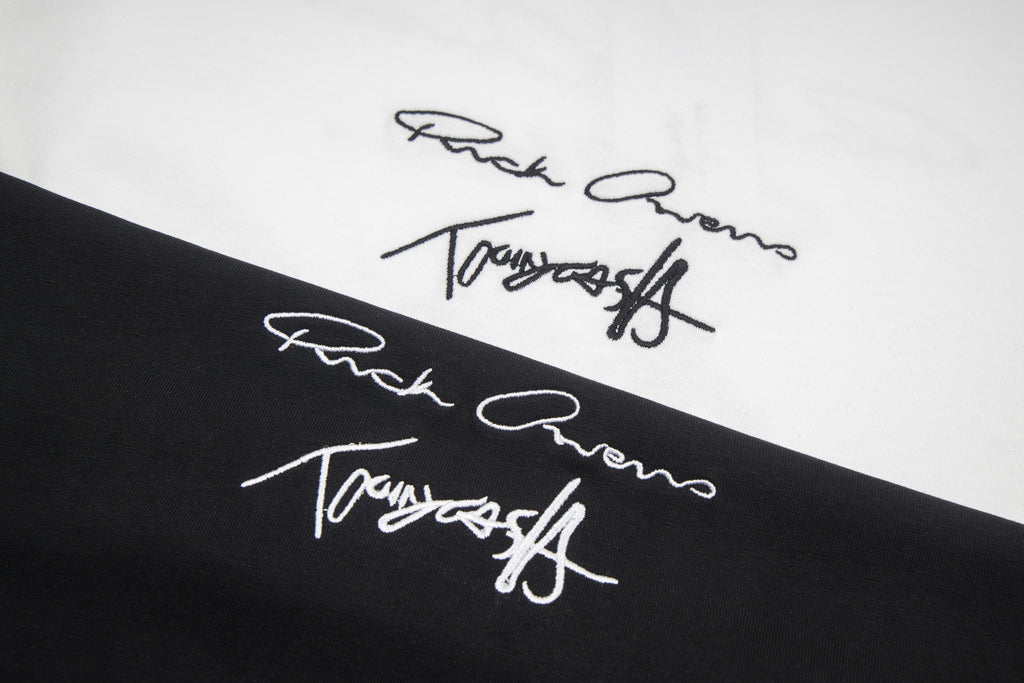 Close-up of signature-style graphic print on black T-shirt