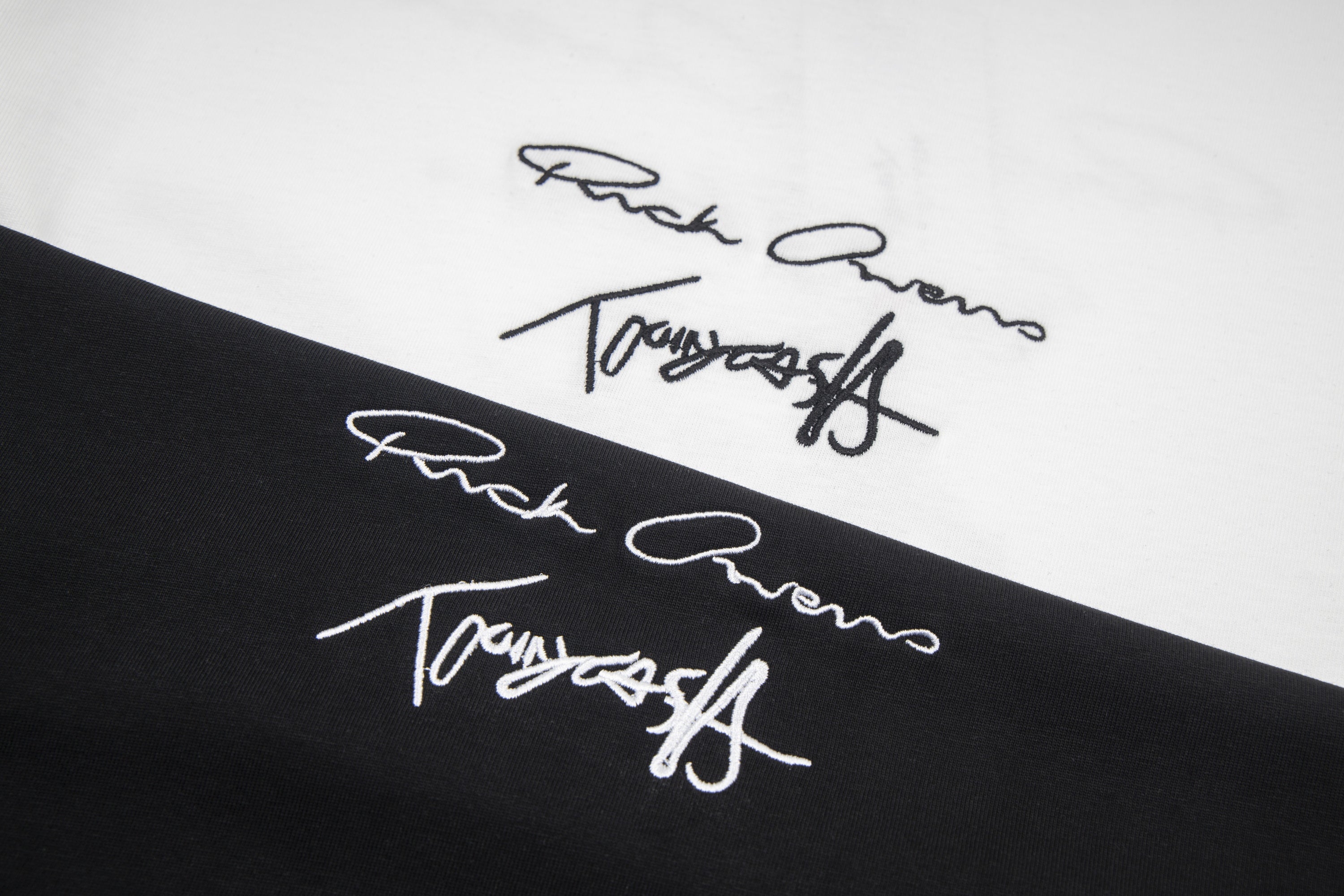 Close-up of signature-style graphic print on black T-shirt