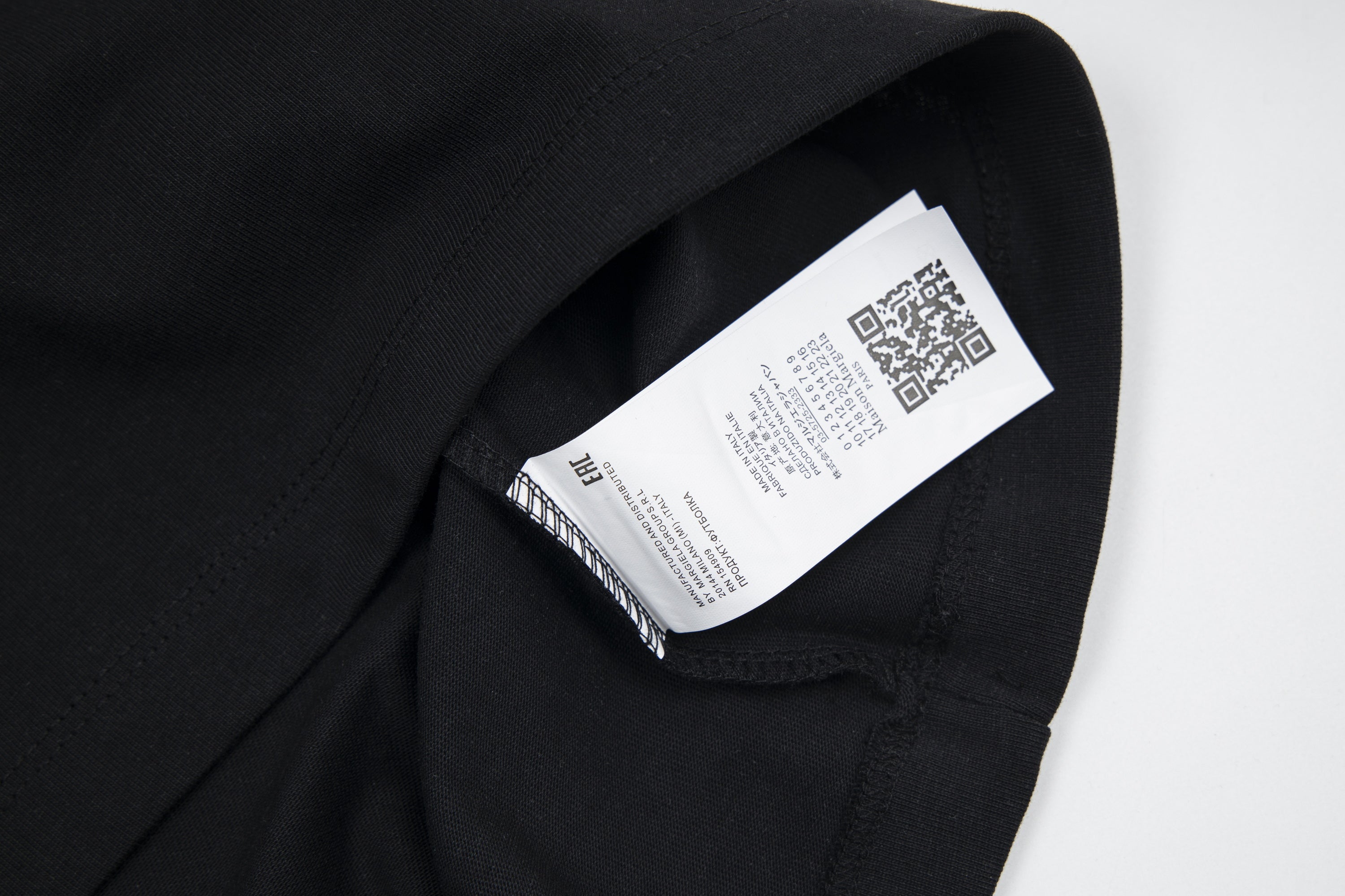 Black T-shirt with interior neck label showing Maison Margiela branding