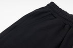 Black elastic waistband and gathered fabric hem close-up