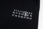 Black shorts with white printed numbers logo on leg