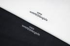 Maison Margiela T-shirt fabric close-up with printed logo text.