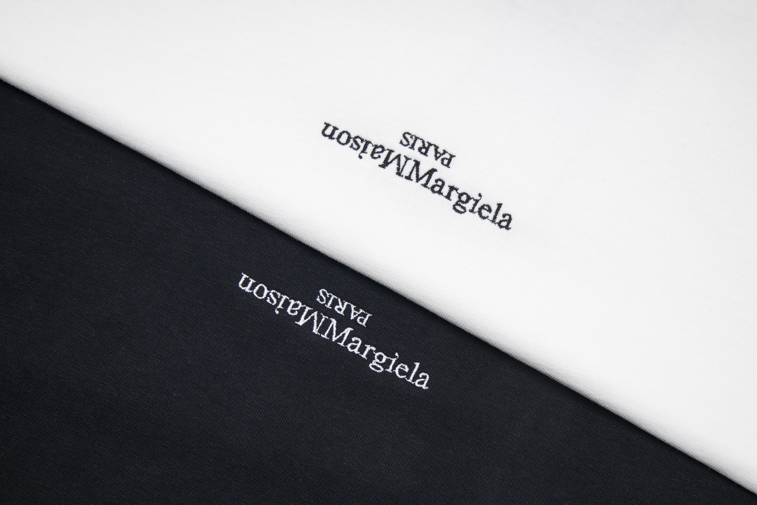Maison Margiela T-shirt fabric close-up with printed logo text.