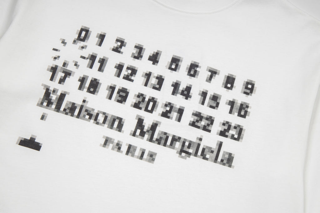 Close-up of white graphic T-shirt print with number pattern and Maison Margiela logo