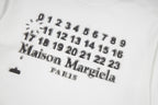 Close-up of white graphic T-shirt print with number pattern and Maison Margiela logo