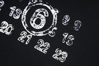 Black T-shirt fabric with white printed number graphic pattern