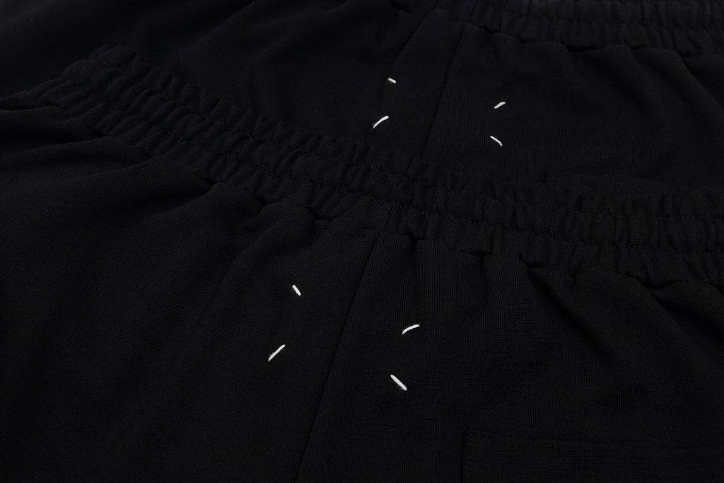 Black shorts close-up of gathered waistband and drawstring