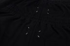 Black shorts close-up of gathered waistband and drawstring