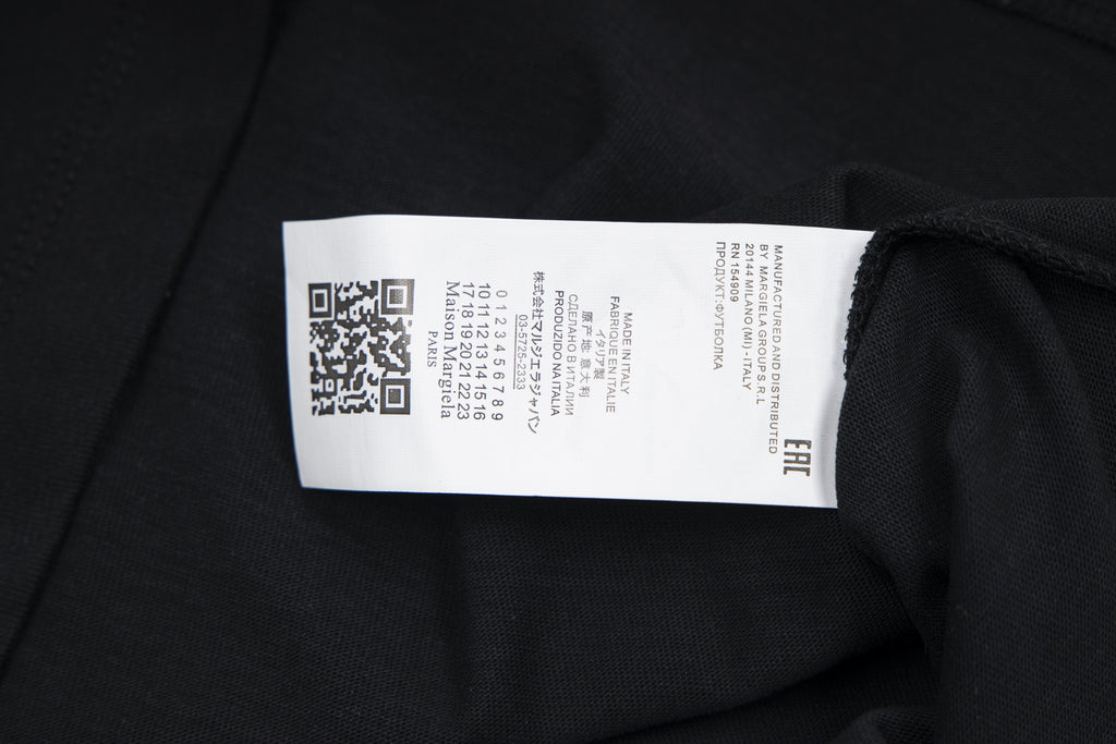 Black T-shirt interior neck label on fabric seam