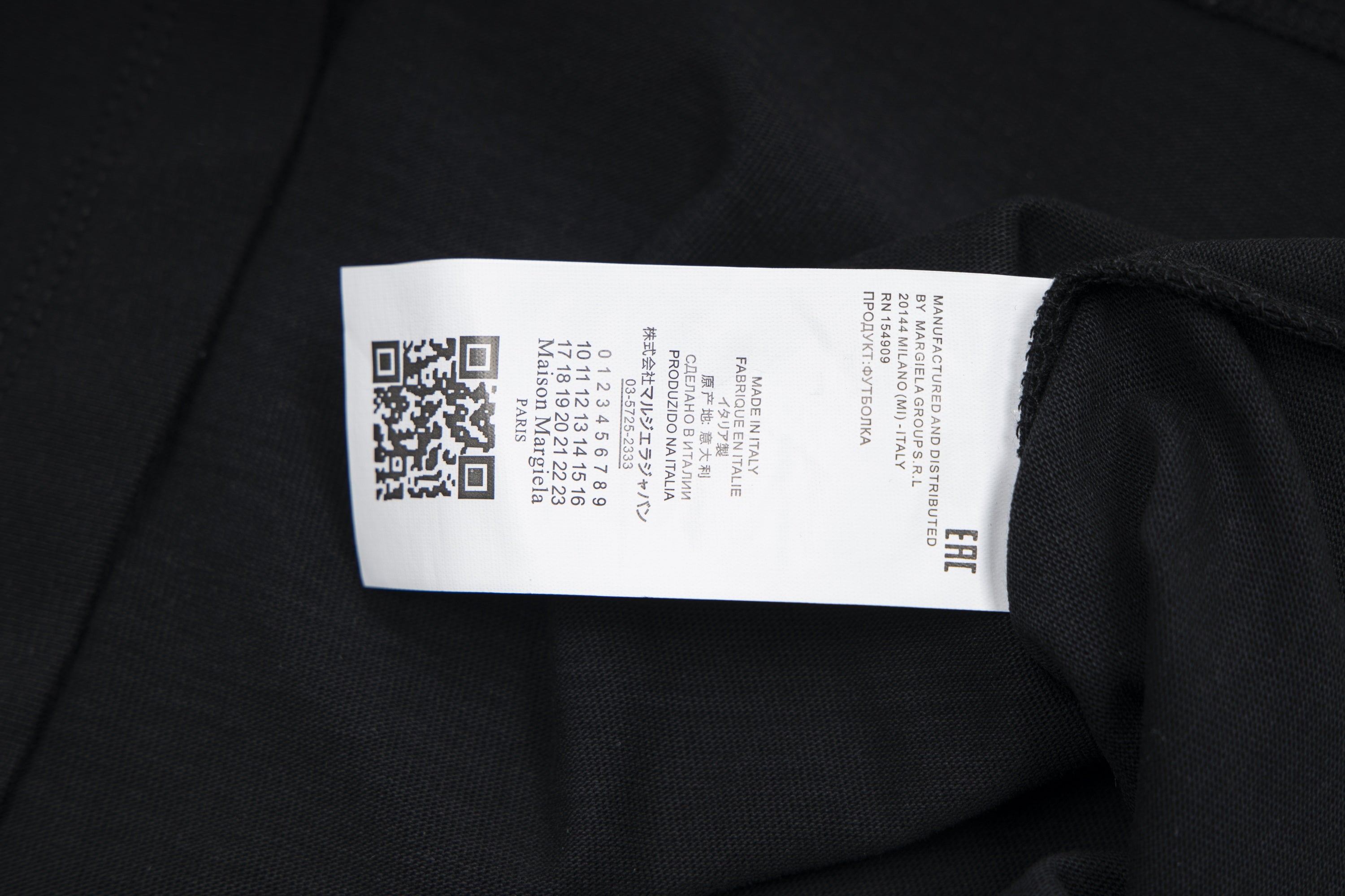 Black T-shirt interior neck label on fabric seam