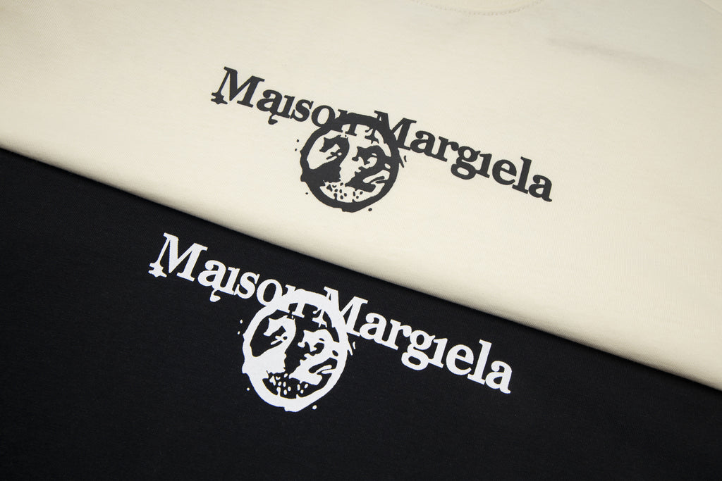 Cream and black folded T-shirts with large Maison Margiela logo print