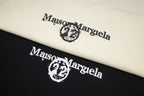Cream and black folded T-shirts with large Maison Margiela logo print