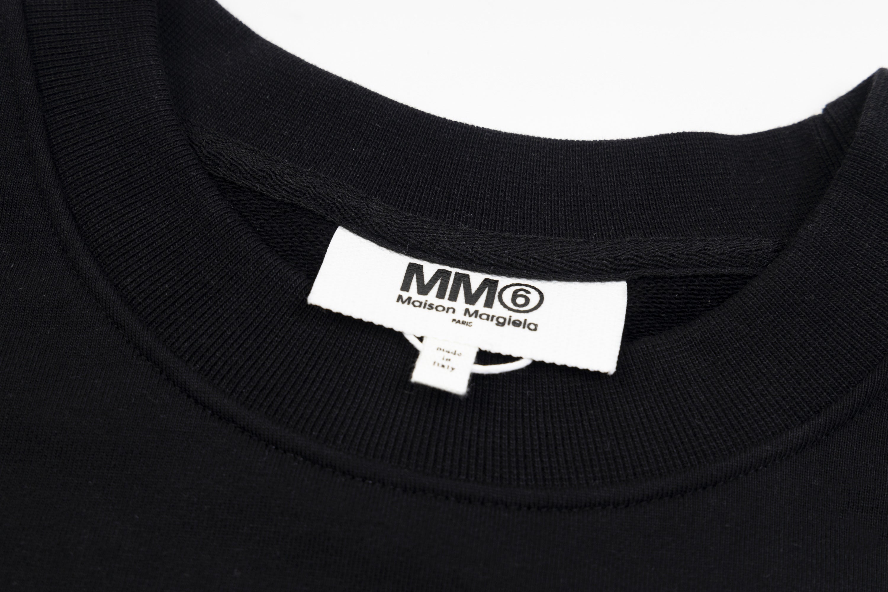 Black crewneck sweatshirt neck label with MM6 Maison Margiela branding