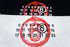 Graphic T-shirt close-up: red face numbers print on black and white fabric