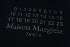 Close-up of dark Maison Margiela Paris number print on black T-shirt