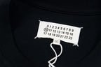 Crewneck black T-shirt with white neck label and Maison Margiela number graphic