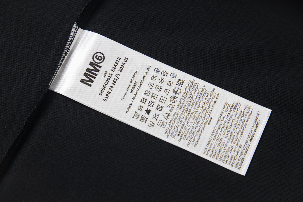 Black T-shirt fabric label with care information and MM6 code