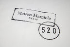 Close-up of Maison Mar giela stamp and 520 circle on T-shirt print