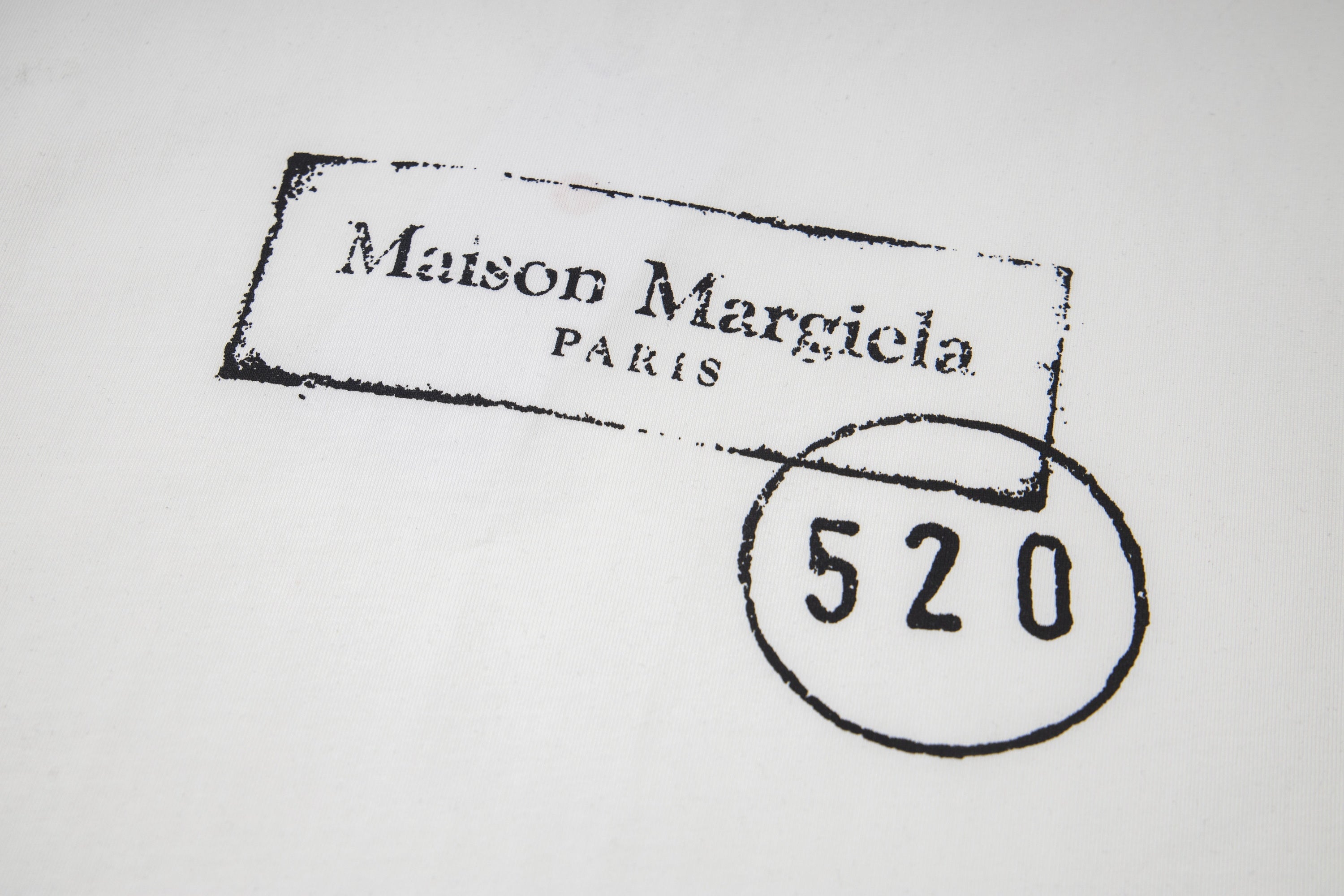 Close-up of Maison Mar giela stamp and 520 circle on T-shirt print