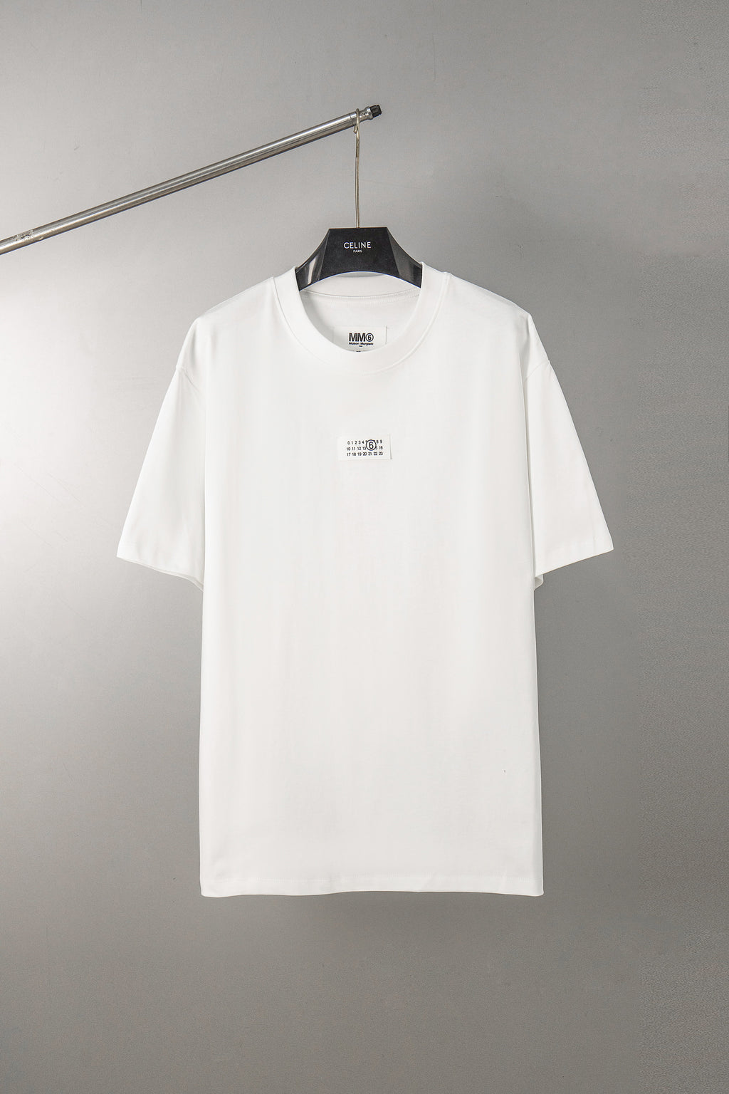 White T-shirt with crew neck and small front logo label, short sleeves