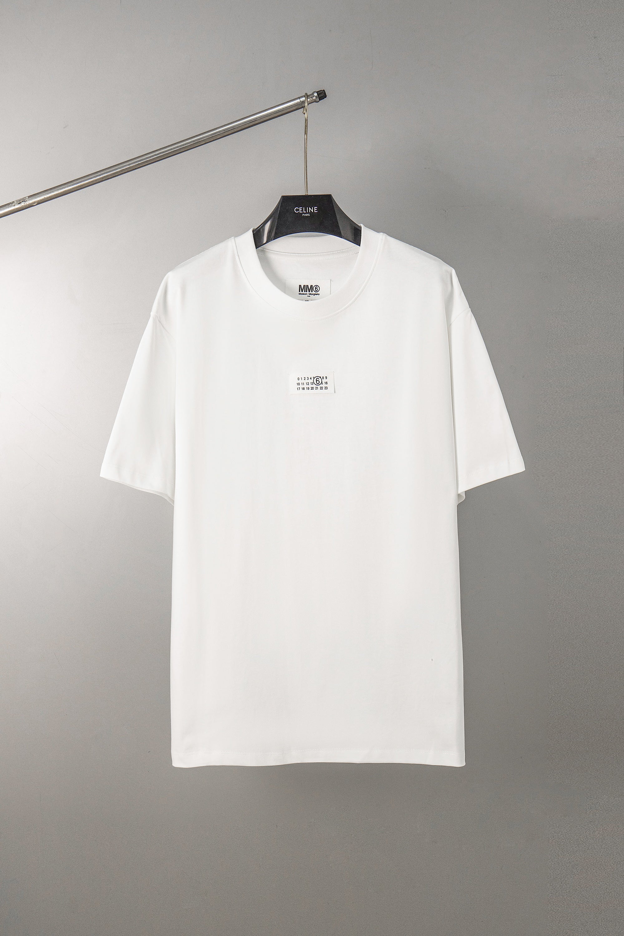 White T-shirt with crew neck and small front logo label, short sleeves