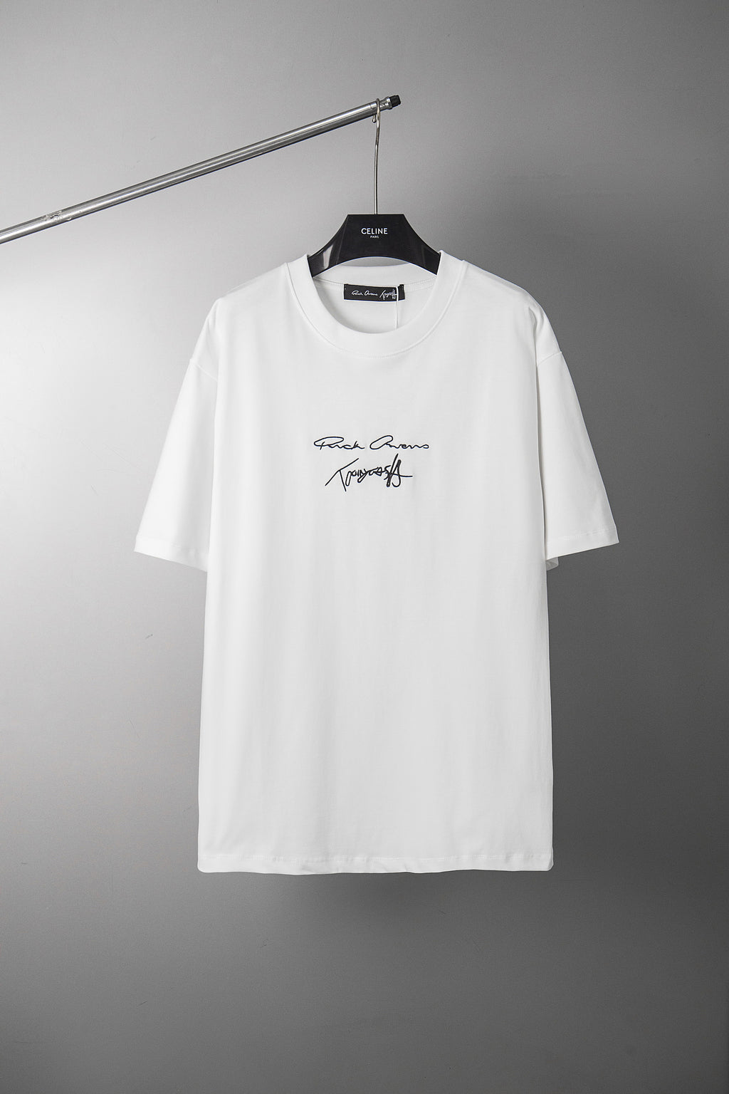 White crewneck T-shirt with small script logo graphic at chest